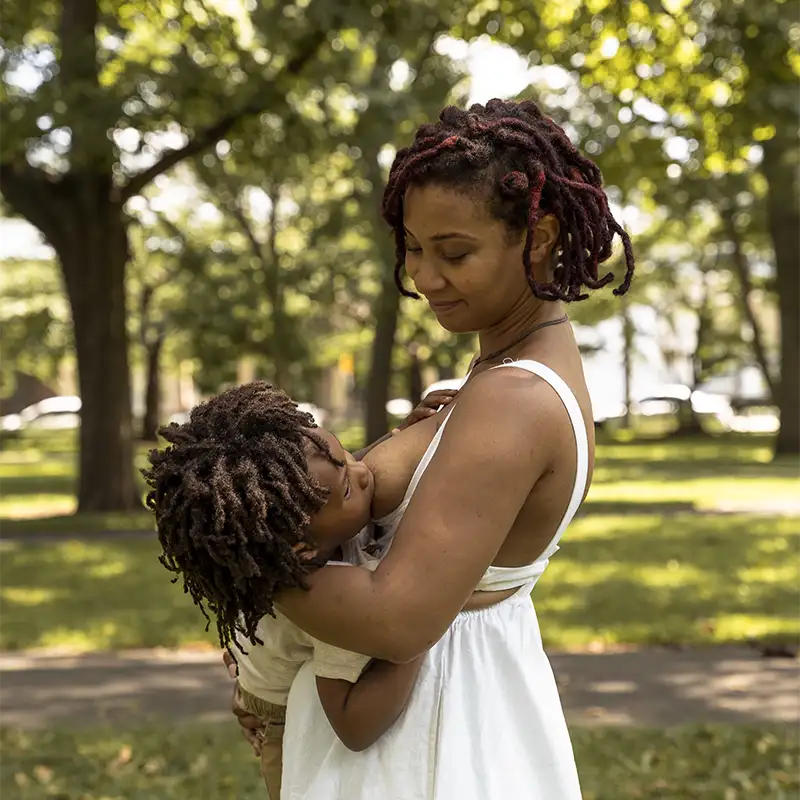 Photo of a mother breast feeding in a public park